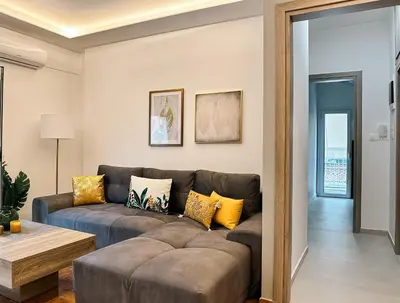 a living room with a couch and a table at Acropolis Aria Apartment-Steps to Metro & Tram in Athens