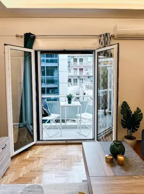 an open living room with a sliding glass door at Acropolis Aria Apartment-Steps to Metro & Tram in Athens