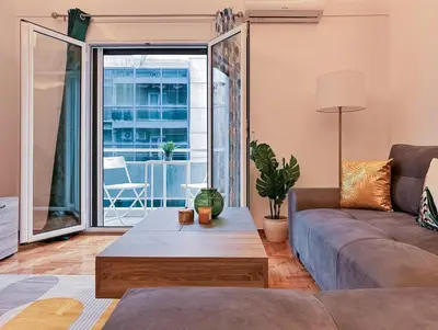 a living room with a couch and a table at Acropolis Aria Apartment-Steps to Metro & Tram in Athens