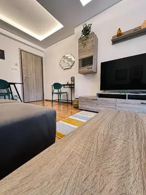 a bedroom with a bed and a flat screen tv at Acropolis Aria Apartment-Steps to Metro & Tram in Athens
