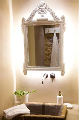 a bathroom with a mirror and a sink at Boutique apartment near Acropolis in Athens
