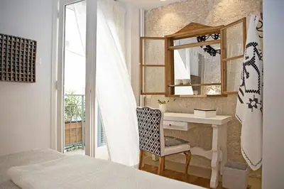 a bedroom with a desk and a mirror and a bed at Boutique apartment near Acropolis in Athens