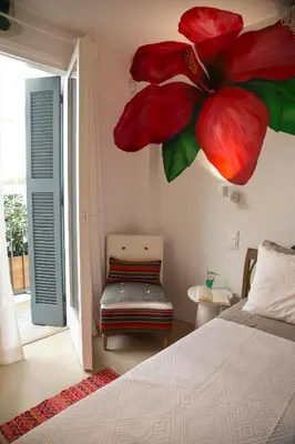 a bedroom with a bed with a large flower on the wall at Boutique apartment near Acropolis in Athens