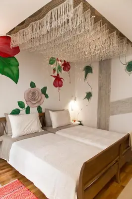 a bedroom with a large bed with flowers on the wall at Boutique apartment near Acropolis in Athens