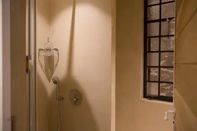 a bathroom with a shower with a shower head on the wall at Boutique apartment near Acropolis in Athens