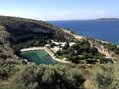 an aerial view of a small island in the ocean at Athens Riviera Hermes Coastal Residence in Athens