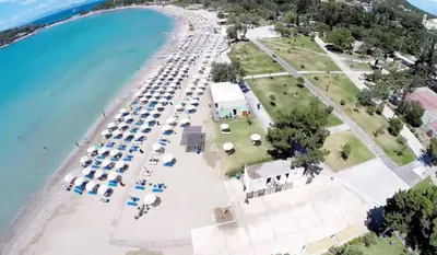 an aerial view of a beach with umbrellas and the ocean at Athens Riviera Hermes Coastal Residence in Athens