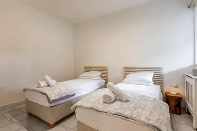 two beds in a bedroom with towels on them at Athens Riviera Hermes Coastal Residence in Athens