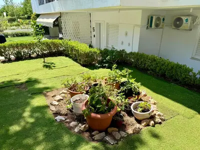 a garden with a bunch of potted plants in a yard at Athens Riviera Hermes Coastal Residence in Athens