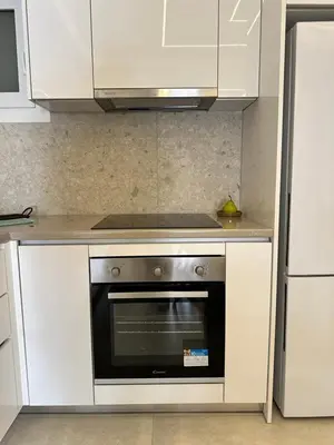 a kitchen with white cabinets and an oven at Kypseli Contemporary Comfort for 6 in Athens