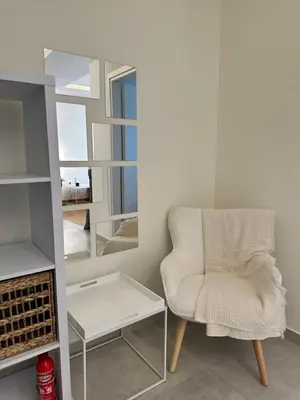 a room with a chair and a mirror at Kypseli Contemporary Comfort for 6 in Athens