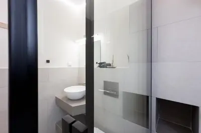 a white bathroom with a sink and a toilet at Three Bedroom Stylish Apt next to Acropolis in Athens