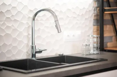 a kitchen sink with a faucet on a counter at Three Bedroom Stylish Apt next to Acropolis in Athens
