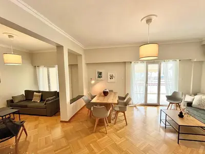 a living room with a couch and a table at Spacious apartment in Athens in Athens