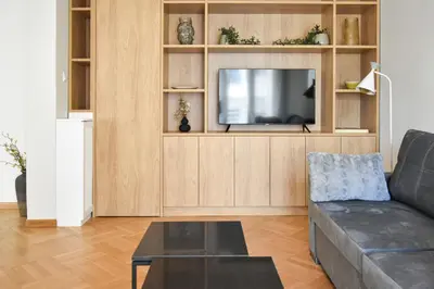 a living room with a couch and a tv at Spacious apartment in Athens in Athens