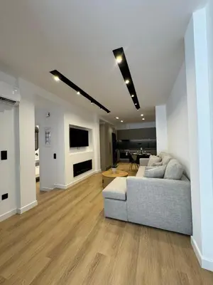 a living room with a couch and a table at PortStay - Complex N71 in Piraeus