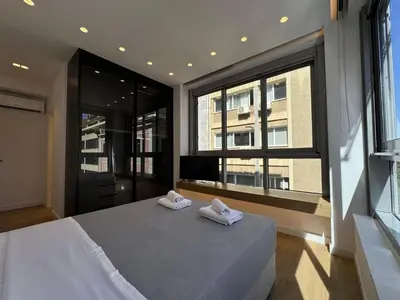 a bedroom with a bed and a large window at PortStay - Complex N71 in Piraeus