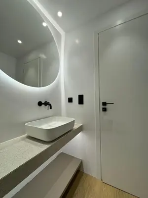a white bathroom with a sink and a mirror at PortStay - Complex N71 in Piraeus