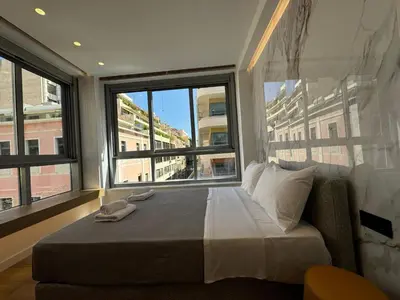 a bedroom with a bed with a large window at PortStay - Complex N71 in Piraeus