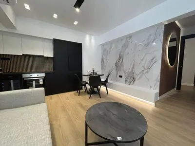 a living room with a table and a kitchen at PortStay - Complex N71 in Piraeus