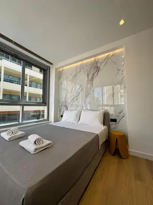 a bedroom with a large bed with towels on it at PortStay - Complex N71 in Piraeus