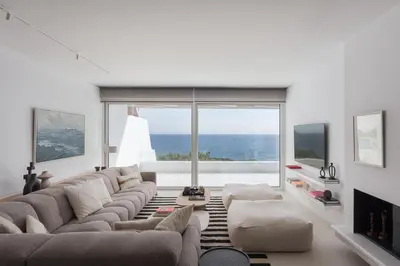 a living room with a large couch and a large window at Casa Amalia in Aghia Marina