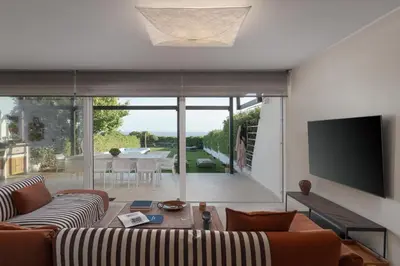 a living room with a couch and a tv at Casa Amalia in Aghia Marina