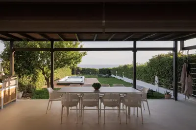 a dining room with a table and chairs on a patio at Casa Amalia in Aghia Marina
