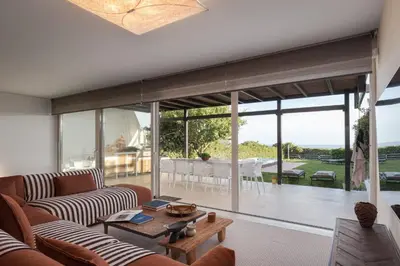 a living room with a couch and a table at Casa Amalia in Aghia Marina