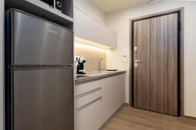 a kitchen with a refrigerator and a sink at Elegant Zen 2BR Apartment in Athens in Athens