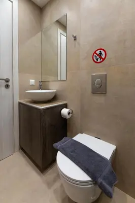 a bathroom with a white toilet and a sink at Elegant Zen 2BR Apartment in Athens in Athens