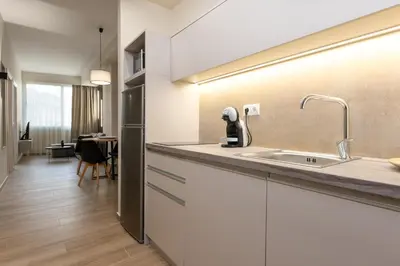 a kitchen with white cabinets and a sink at Elegant Zen 2BR Apartment in Athens in Athens