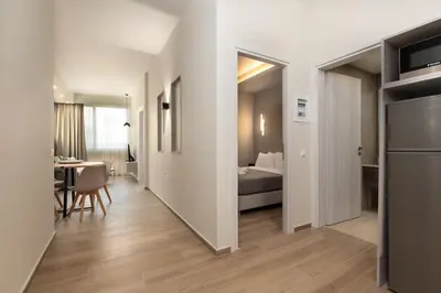 a room with a bed and a dining room with a table at Elegant Comfort 2BR Apartment in Athens in Athens