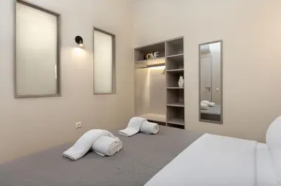 a white bedroom with two white towels on a bed at Elegant Comfort 2BR Apartment in Athens in Athens