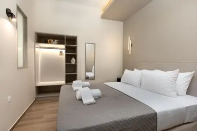 a bedroom with a large bed with white pillows at Elegant Comfort 2BR Apartment in Athens in Athens