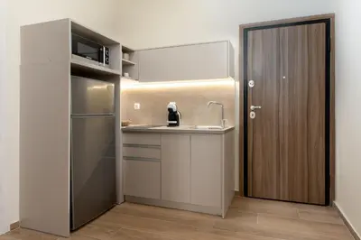 a kitchen with a sink and a refrigerator at Elegant Comfort 2BR Apartment in Athens in Athens