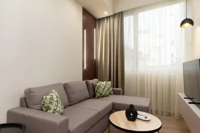 a living room with a couch and a table at Elegant Comfort 2BR Apartment in Athens in Athens