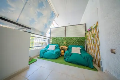 a room with two bean bags and a table at Lux Apartment next to the sea in Piraeus