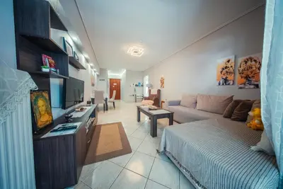 a living room with a bed and a couch at Lux Apartment next to the sea in Piraeus