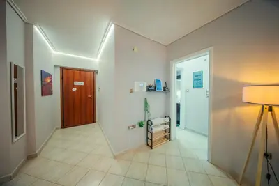 a hallway with a door and a room with a hallway at Lux Apartment next to the sea in Piraeus