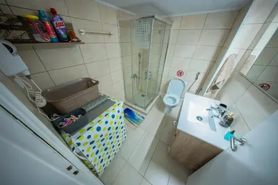 a bathroom with a shower and a toilet and a sink at Lux Apartment next to the sea in Piraeus