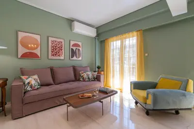 a living room with a couch and a table at Elegant Escape 2BR BA Sunny Apt in Athens
