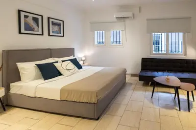 a bedroom with a large bed and a couch at Phaedrus Living Athens City Studios Angel in Athens