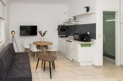 a kitchen with a small table and a table and chairs at Phaedrus Living Athens City Studios Angel in Athens