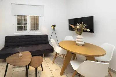 a living room with a couch and a table at Phaedrus Living Athens City Studios Angel in Athens