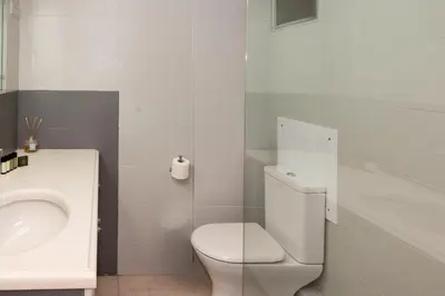 a white bathroom with a toilet and a sink at Phaedrus Living Athens City Studios Angel in Athens
