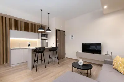 a living room with a couch and a kitchen at Elegant Studio Apartment in Athens in Athens