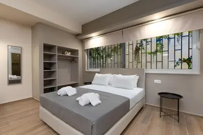a bedroom with a large bed with white pillows at Elegant Studio Apartment in Athens in Athens