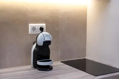 a coffee machine is plugged into a wall at Elegant Studio Apartment in Athens in Athens