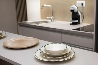 a kitchen counter with plates and a bowl on it at Elegant Studio Apartment in Athens in Athens